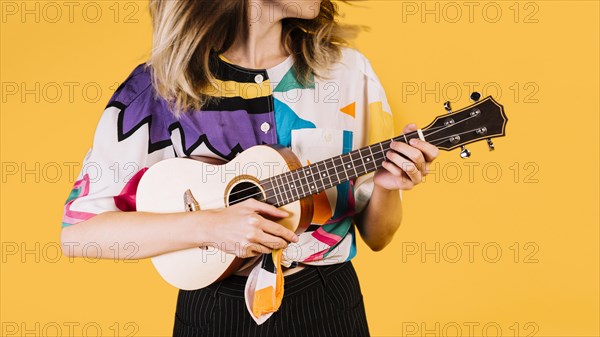 girl playing ukelele