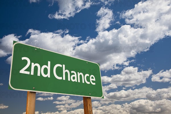 2nd chance green road sign and dramatic clouds background