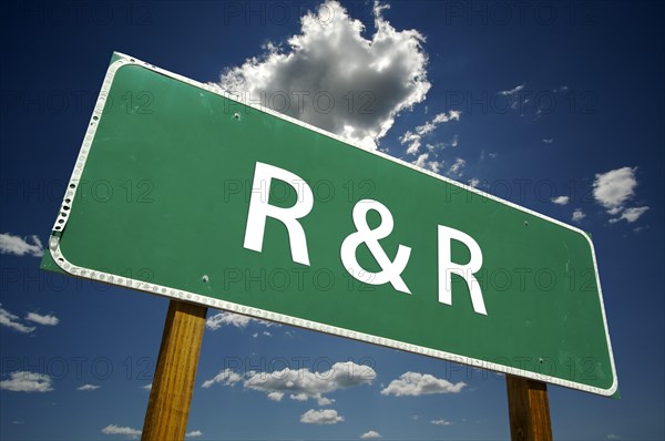 R and R road sign with dramatic clouds and sky
