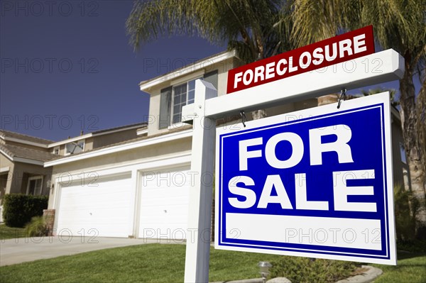Foreclosure for sale real estate sign in front of house