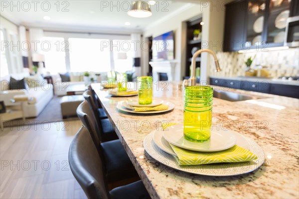 Abstract of beautiful kitchen granite counter place settings and chairs