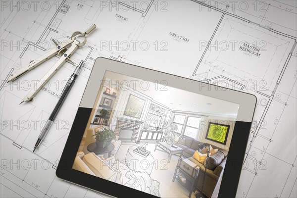 Computer tablet showing living room illustration sitting on house plans with pencil and compass