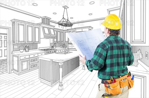 Male contractor with hard hat and plans looking at custom kitchen drawing on white