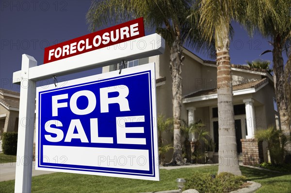 Foreclosure for sale real estate sign in front of house