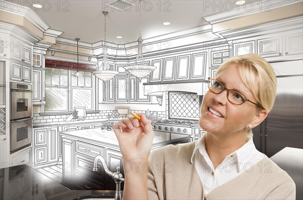 Creative woman with pencil over custom kitchen design drawing and photo combination