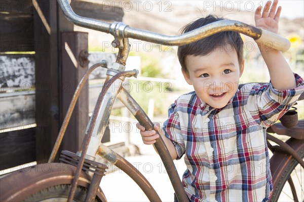 Cute mixed-race young boy having fun on the bicycle
