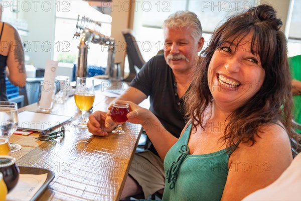 Group of friends enjoying glasses of micro brew beer at bar