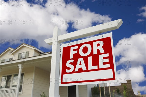 Home for sale sign in front of new house