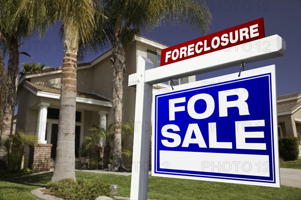 Foreclosure for sale real estate sign in front of house