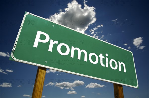 Promotion road sign with dramatic clouds and sky