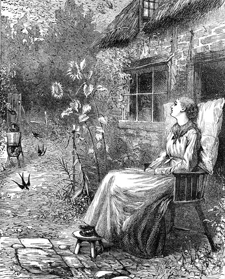 Young woman sitting in the garden in summer