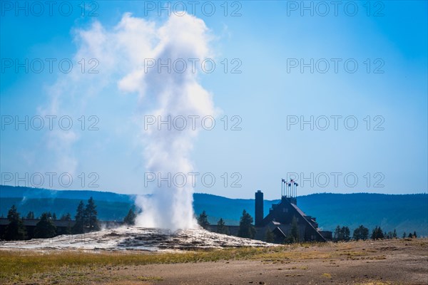 Old faithful geyser erupting at yellowstone national park