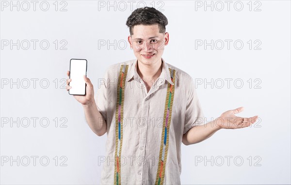 Handsome man smiling positive showing mobile phone blank screen with another hand palm open