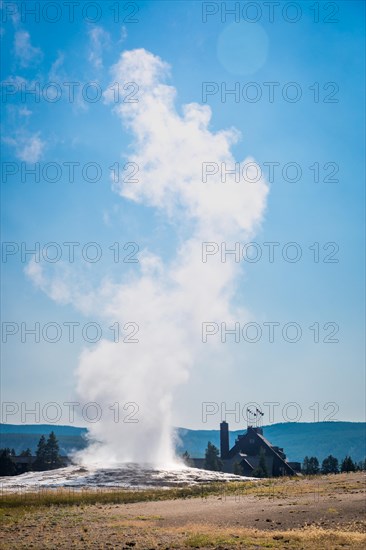 Old faithful geyser erupting at yellowstone national park