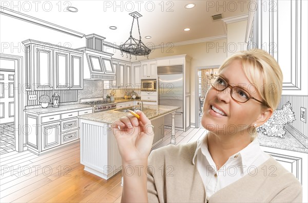 Creative woman with pencil over custom kitchen design drawing and photo combination