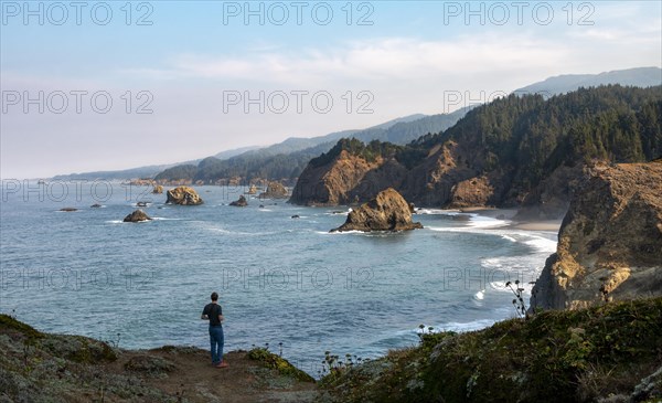 Young man standing on cliff