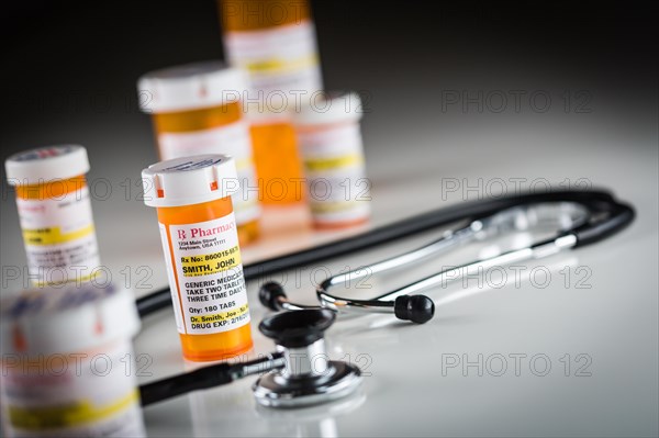 Several non-proprietary medicine prescription bottles abstract with stethiscope