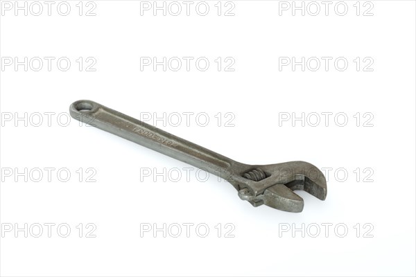 Old adjustable spanner isolated on white background