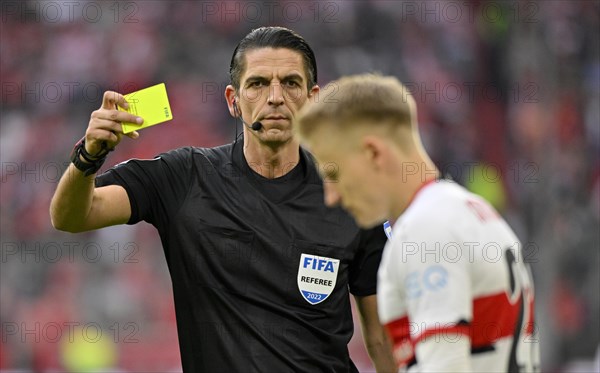 Referee Deniz Aytekin shows yellow card to Chris Fuehrich VfB Stuttgart