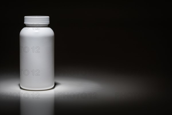 Blank white bottle ready for your text under spot light