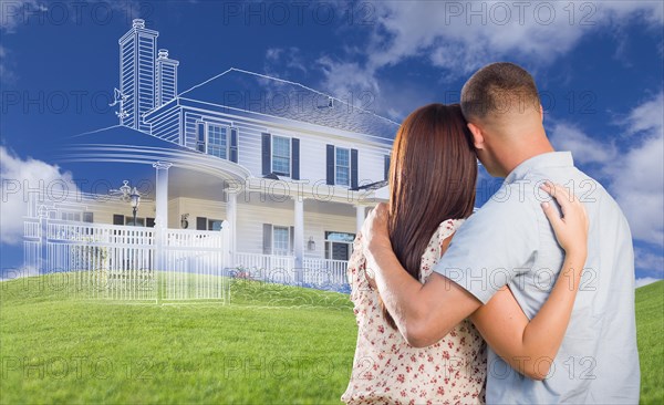 Young military couple facing ghosted house drawing