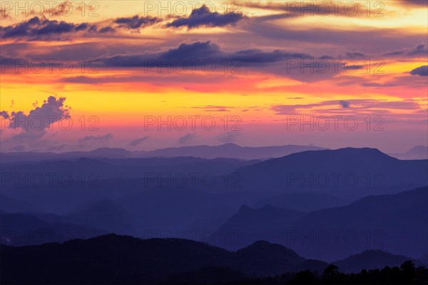 Silhouettes of hills in valley on sunset. Pothamedu viewpoint