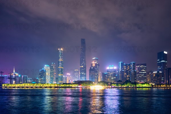 Guangzhou cityscape skyline over the Pearl River illuminated in the evening. Guangzhou