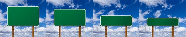 Set of different sized blank green road signs over clouds and blue sky