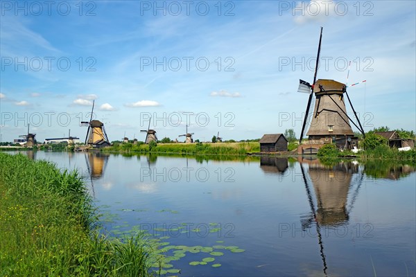Historic windmills reflected in a canal