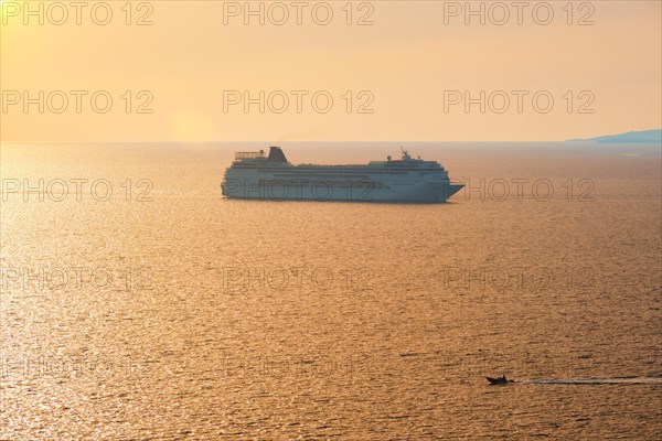 Cruise ship and yacht boat silhouettes in Aegean sea on sunset