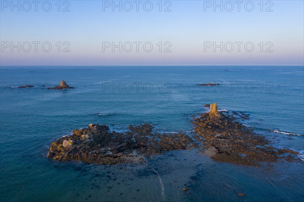 Aerial view of rock formations in the sea in front of the sandy beach Ker Emma shortly in front of sunset