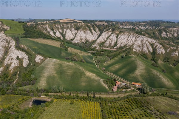 Aerial view of a hilly landscape with erosion valleys
