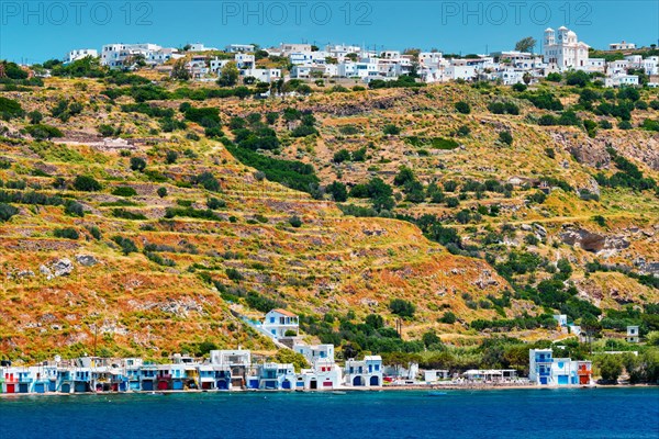 Klima and Plaka villages with whitewhashed traditional houses and orthodox church and windmills on Milos island