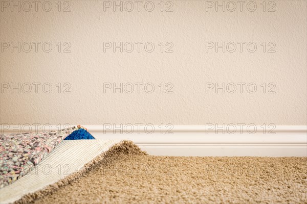 Pulled back carpet and underlay in room of house