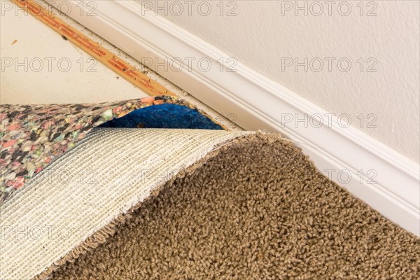 Pulled back carpet and underlay in room of house