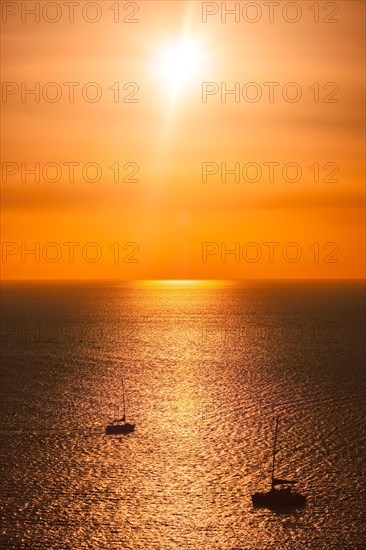 Yacht boats silhouettes in Aegean sea on sunset. Mykonos