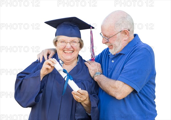 Senior woman and graduate in hat and gown being congratulated by husband isolated on white