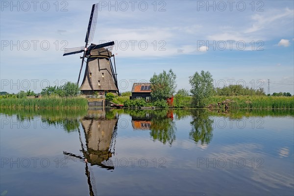 Historic windmill reflected in a canal