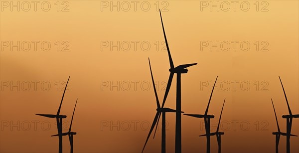 Windmill at sunset against light