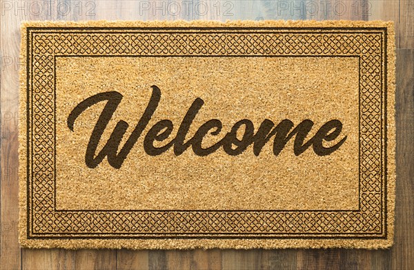 Welcome mat on A wood floor background
