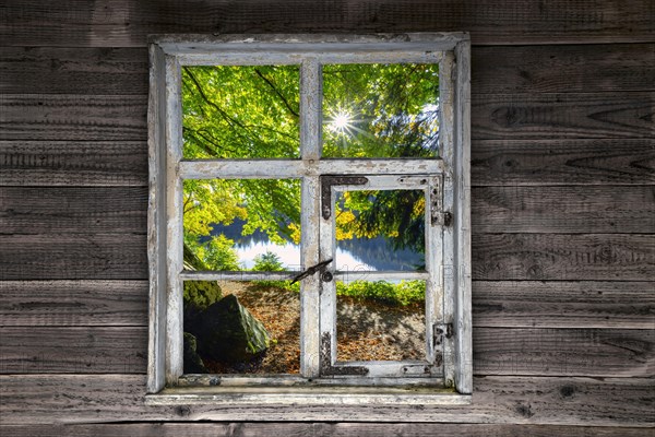 View through a rustic wooden window onto the Feldsee