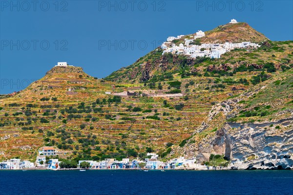 Klima and Plaka villages with whitewhashed traditional houses and orthodox church and windmills on Milos island