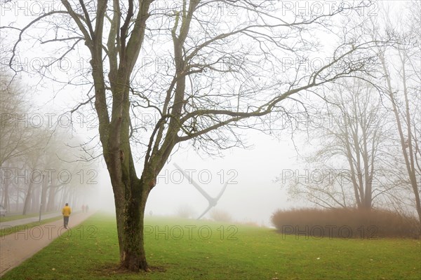 Stroller in the morning fog on the Hiroshima bank on the Fulda with pickaxe