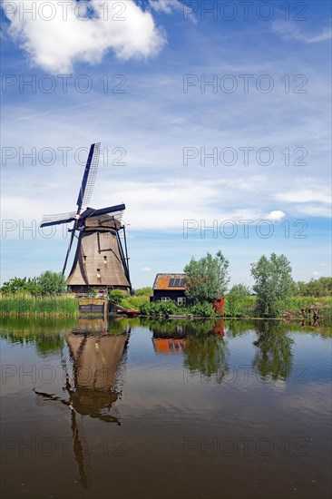 Historic windmill reflected in a canal
