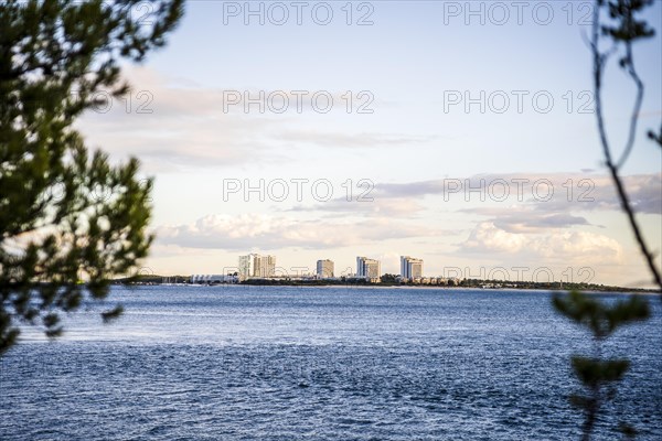 Cityscape of Troia by sunset with Atlantic ocean and trees in the foreground