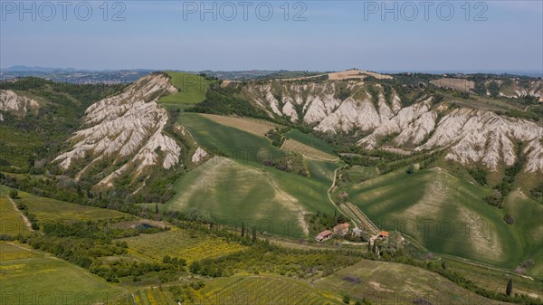 Aerial view of a hilly landscape with erosion valleys
