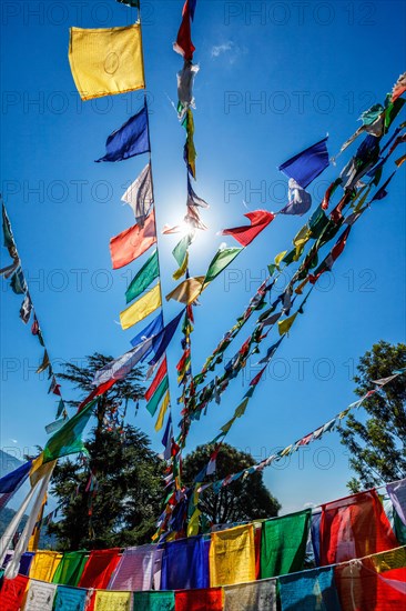 Buddhist prayer flags lungta with Om Mani Padme Hum Buddhist mantra prayer meaning Praise to the Jewel in the Lotus on kora around Tsuglagkhang complex