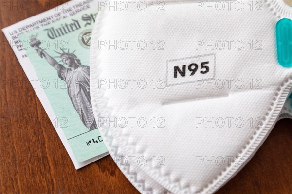 N95 medical face mask resting on IRS covid-19 economic relief check