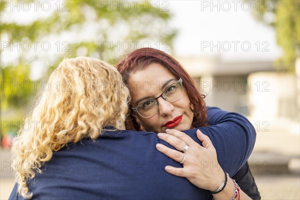 Couple of lesbian women hugging in a park