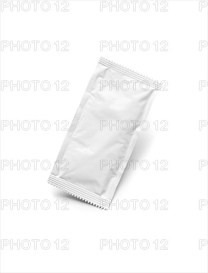 Blank white condiment packet floating isolated on white background